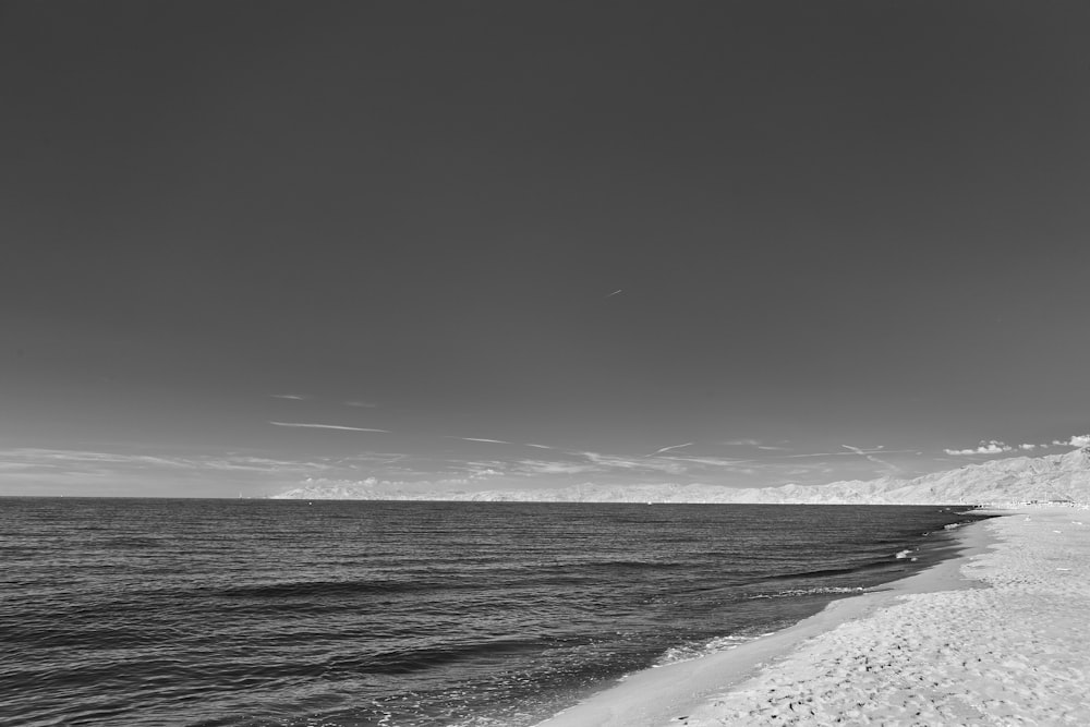 a black and white photo of a beach