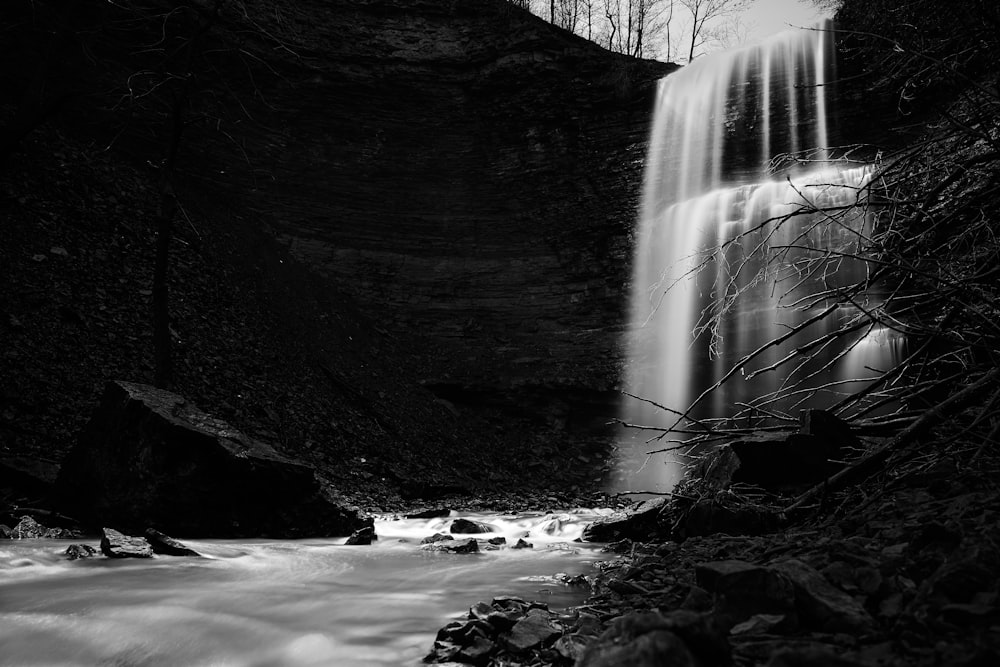 a black and white photo of a waterfall