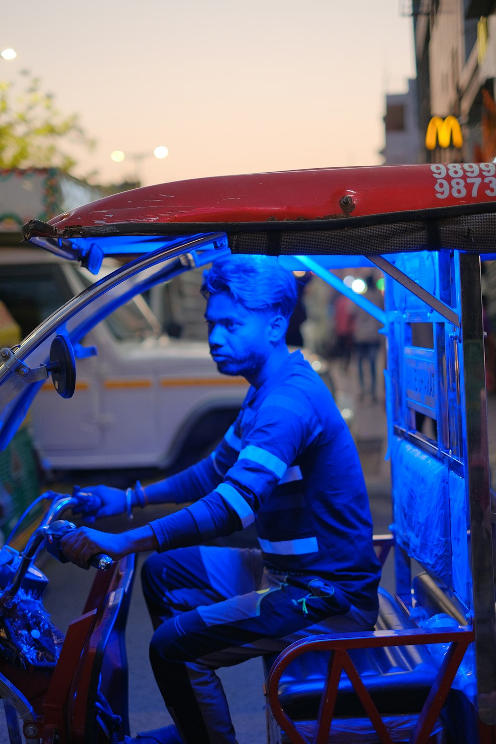 a man on a motorcycle with a blue face painted on it