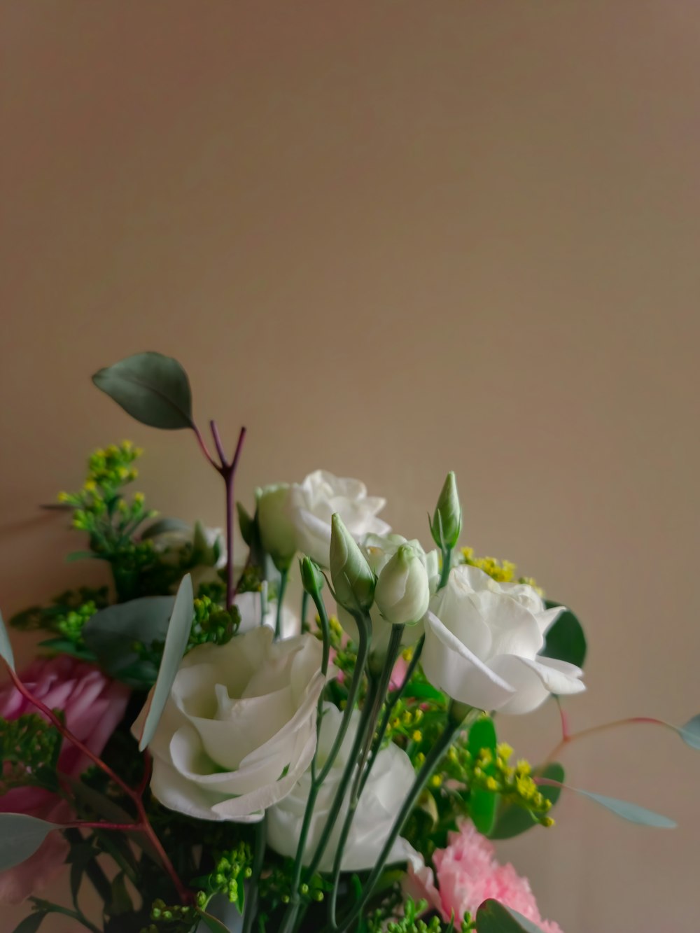 a vase filled with white and pink flowers