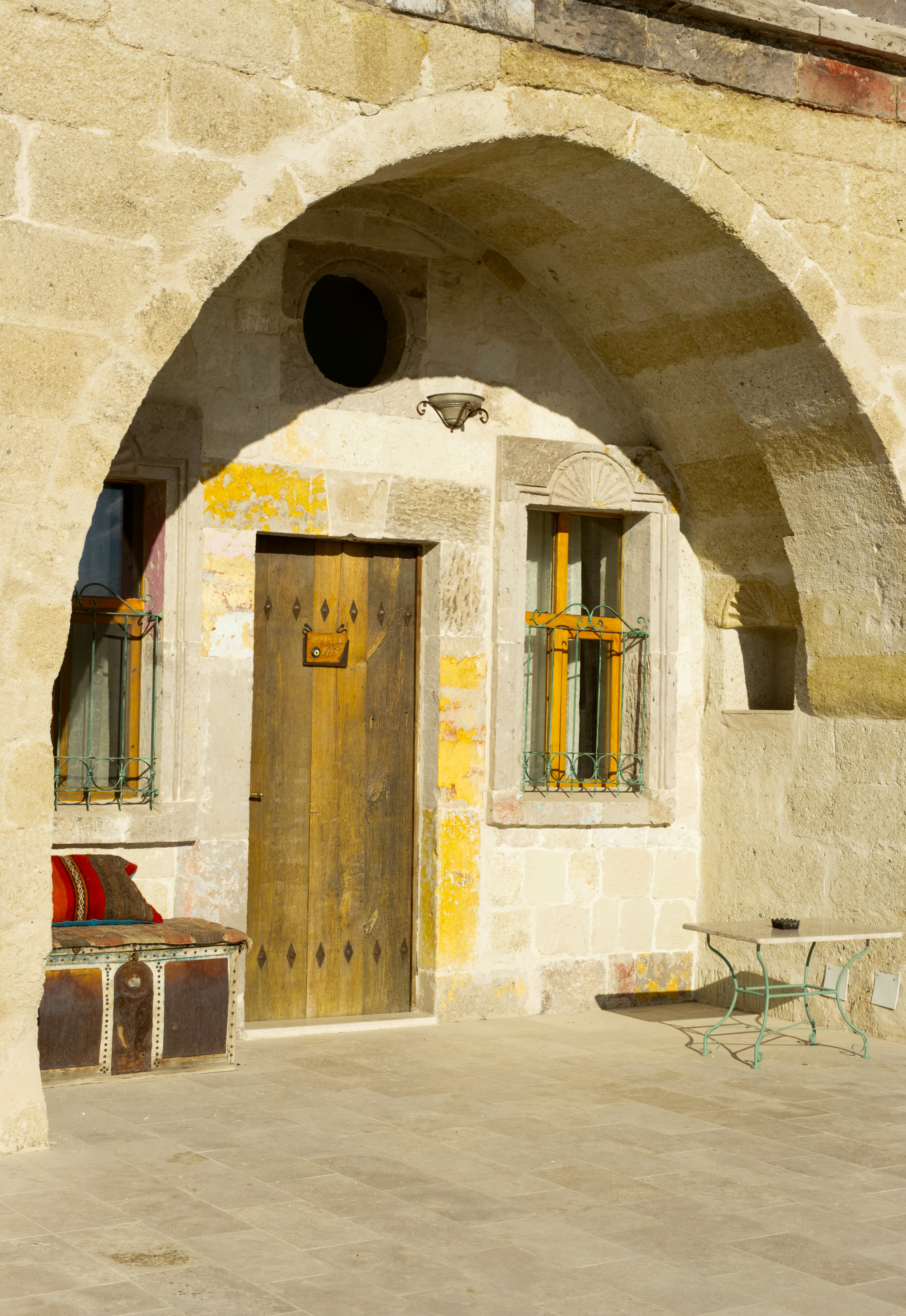 a stone building with a wooden door and window