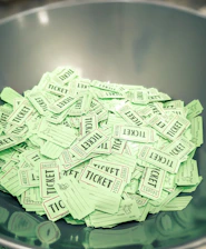 a bowl full of tickets sitting on top of a table