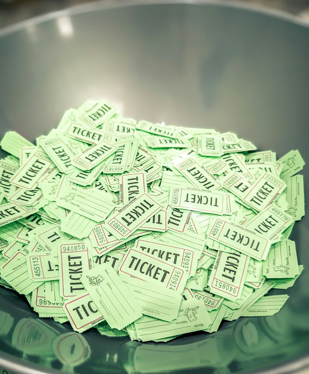 a bowl full of tickets sitting on top of a table