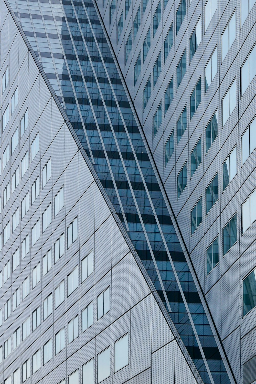 a very tall building with many windows next to another building