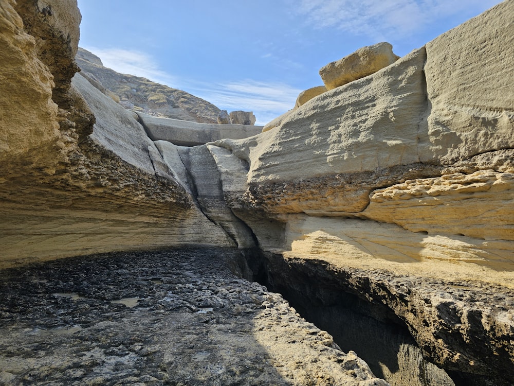 a large rock formation with a small crack in the middle