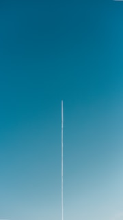 a plane is flying high in the sky