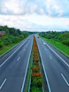 a highway with a line of cars driving down it