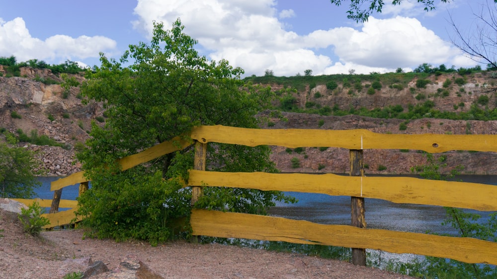 a wooden fence with a river in the background