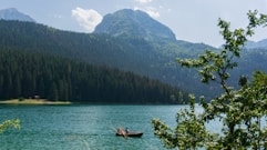 a couple of boats floating on top of a lake