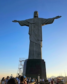 a crowd of people standing around a large statue