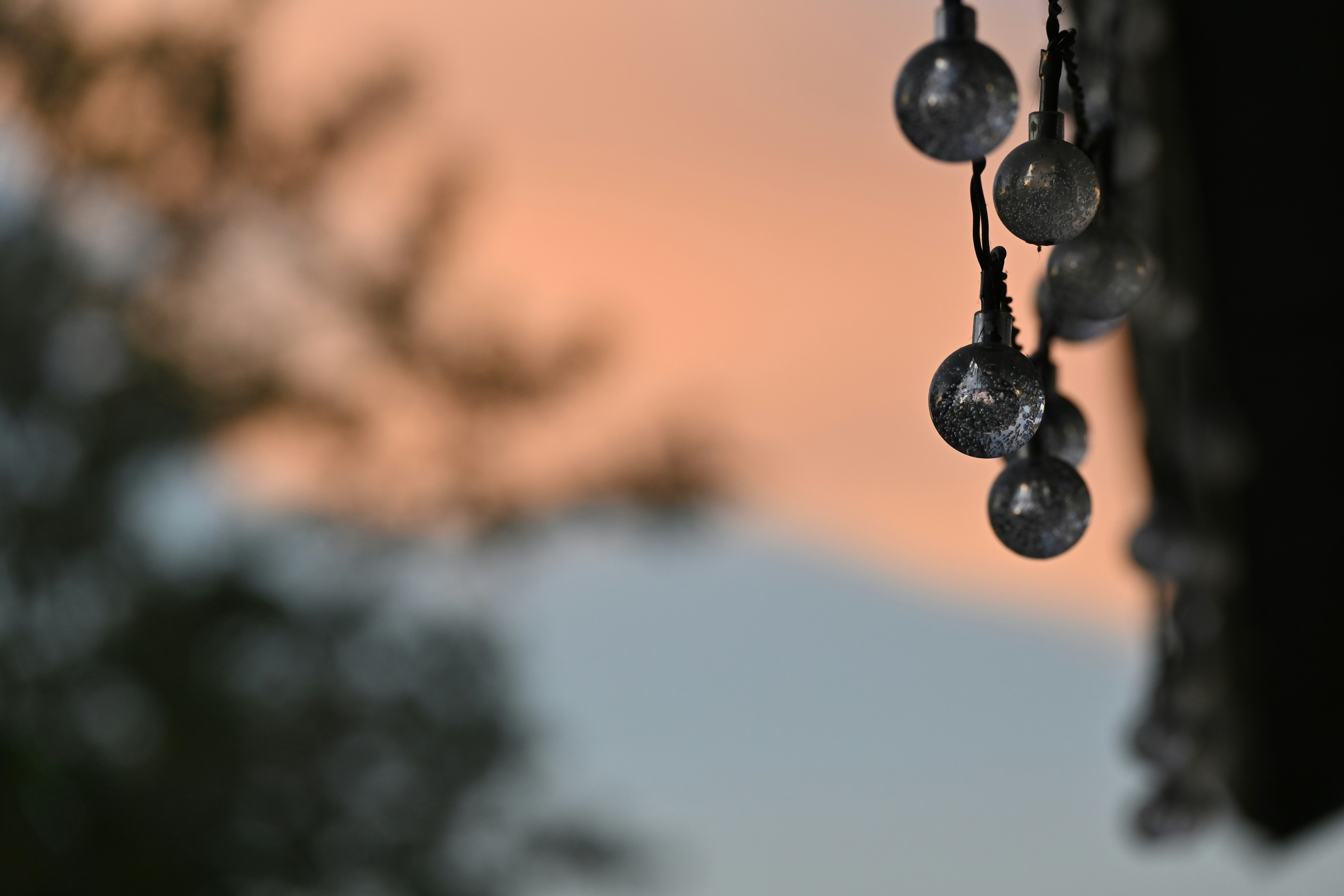 a group of glass balls hanging from a window
