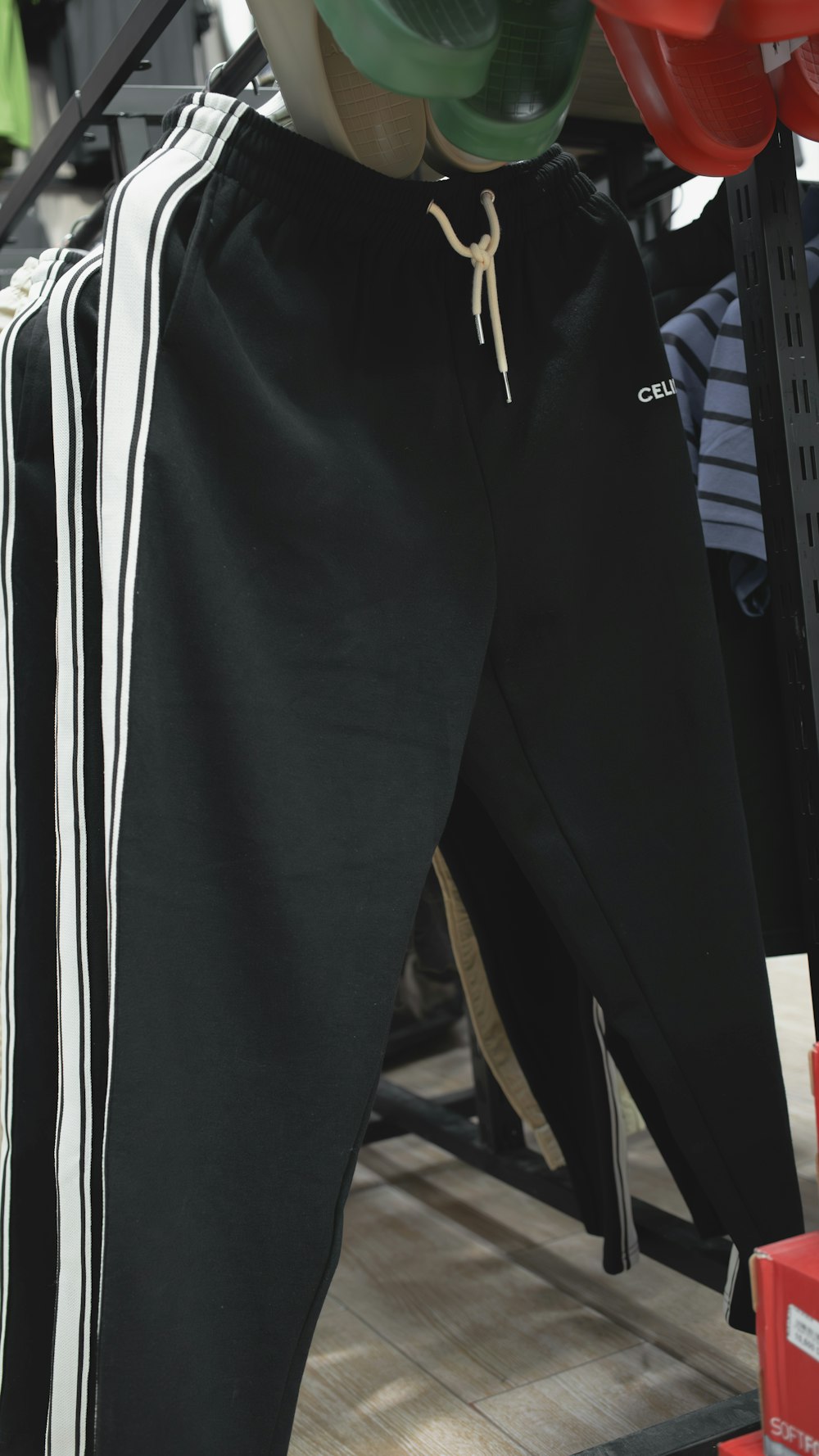 a pair of black and white pants hanging from a rack