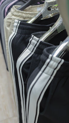 a row of black and white shorts hanging on a rack