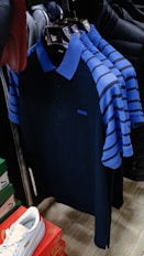 a bunch of shirts hanging on a rack