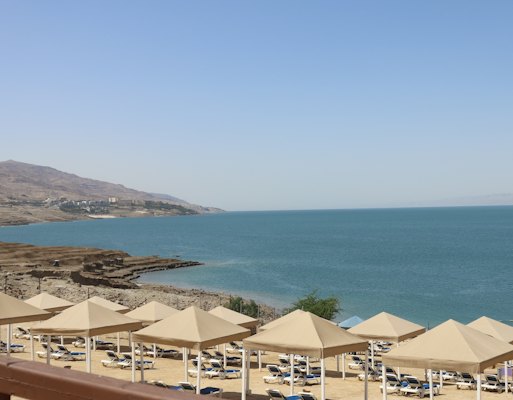 A bunch of umbrellas that are on a beach — Dead Sea, Jordan