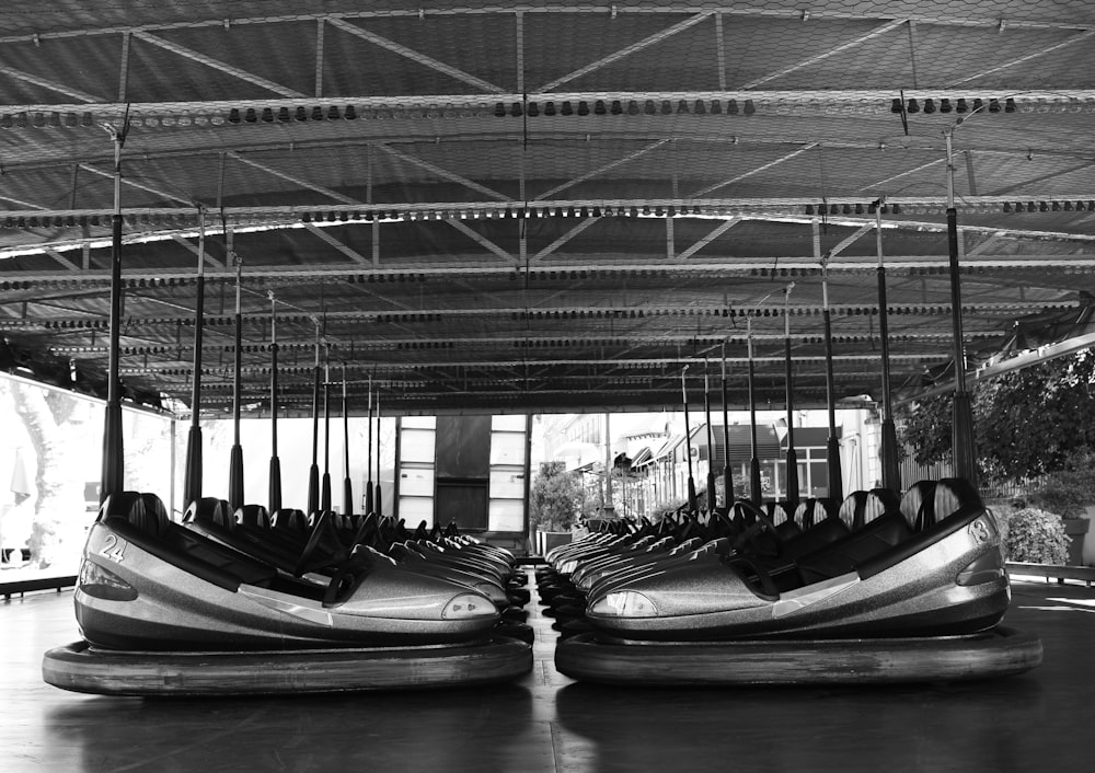 a black and white photo of a row of bumper boats