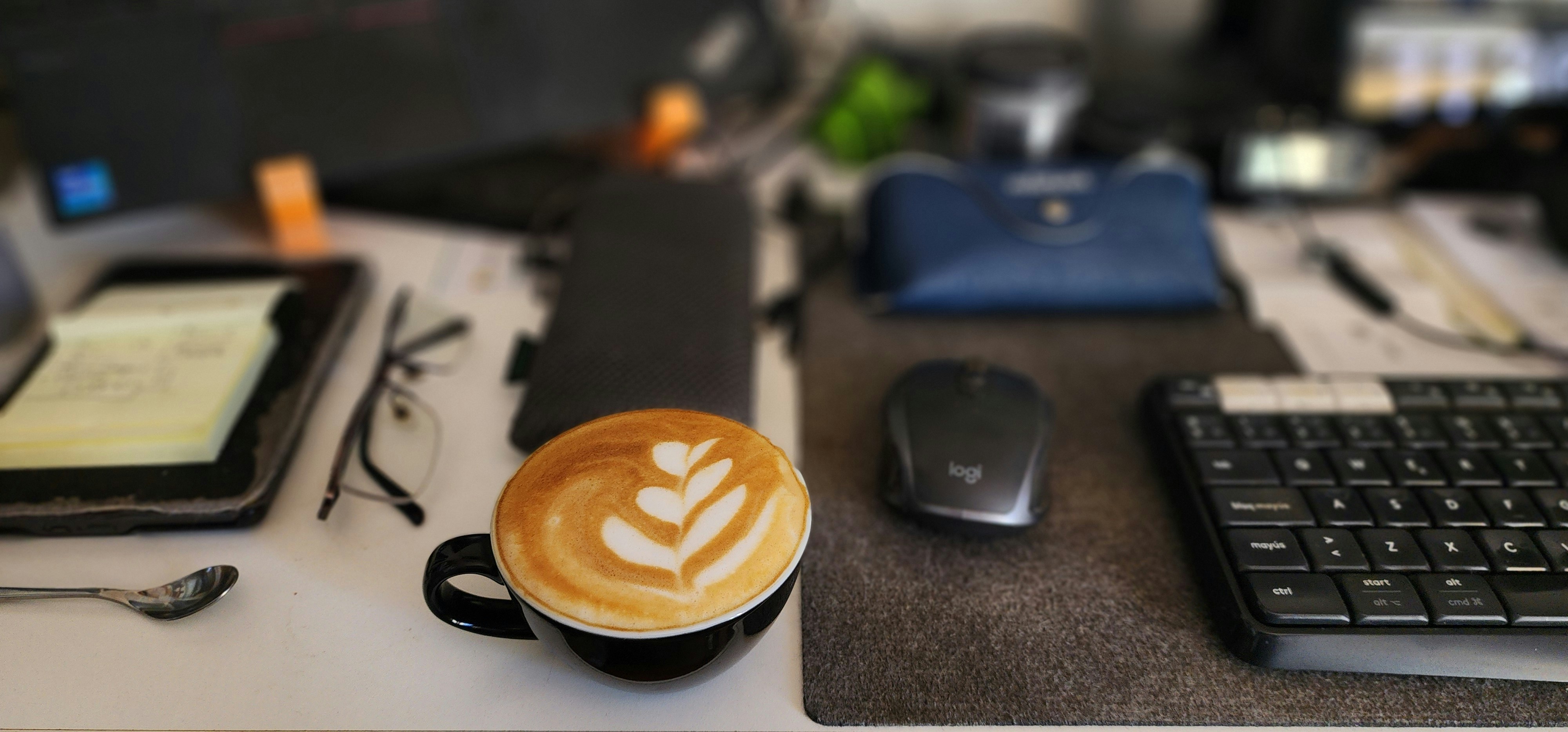 Coffee cup on desk next to keyboard