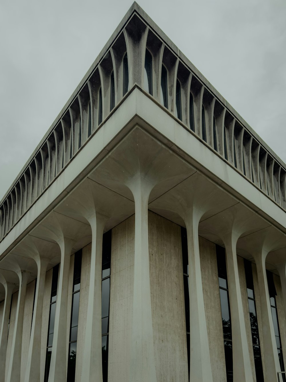 a tall building with columns and a sky background