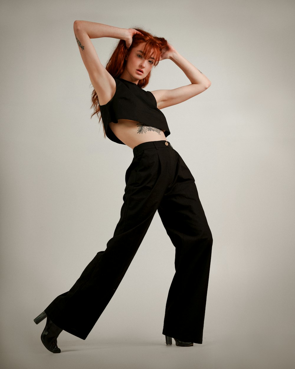 a woman in a black top and black pants