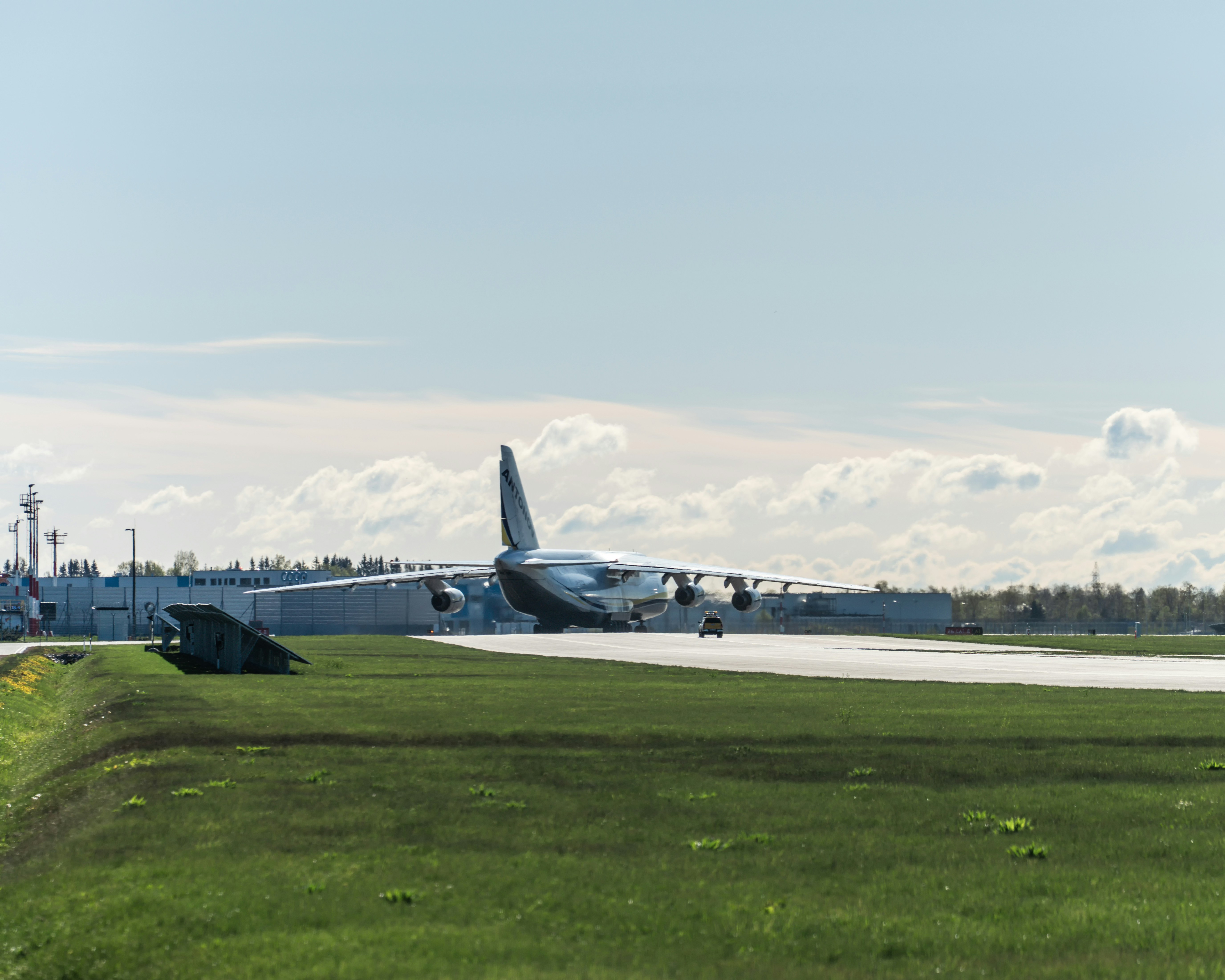 a large jetliner sitting on top of an airport runway, 