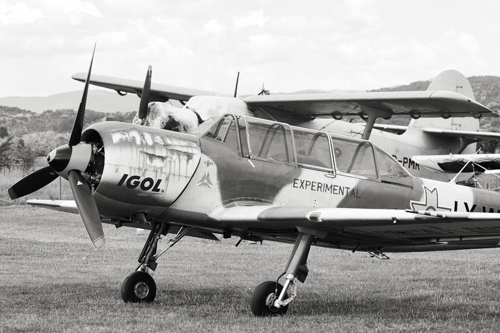 a small airplane sitting on top of a grass covered field