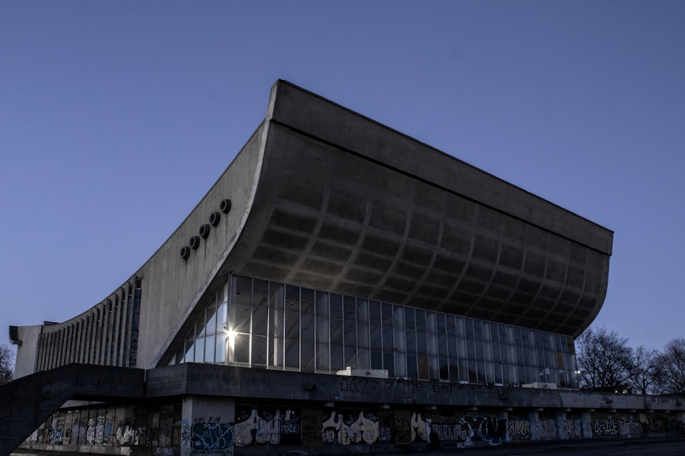 a building with a curved roof and graffiti on the side of it