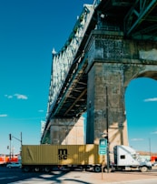 a semi truck is driving under a bridge