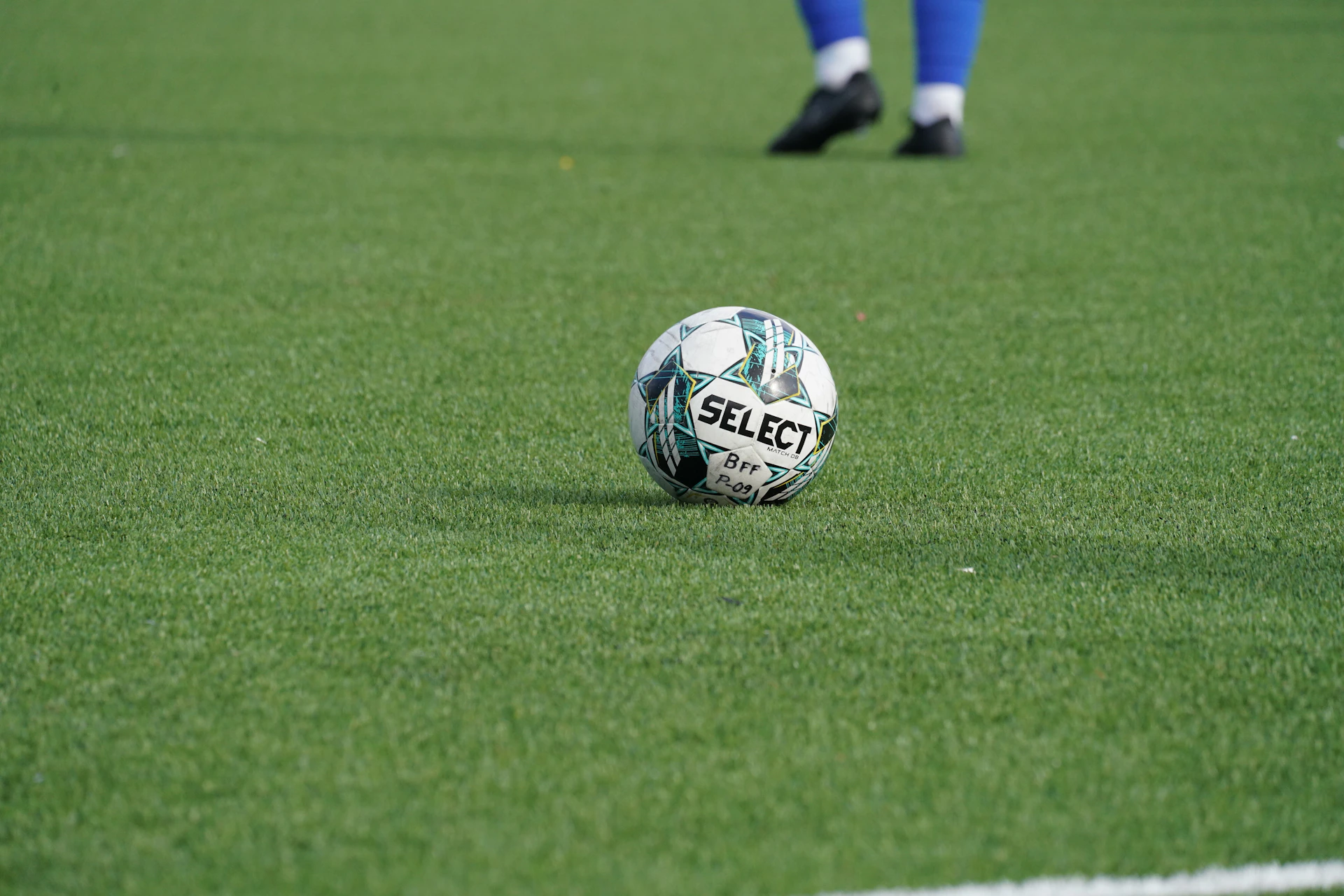 a soccer ball sitting on top of a green field