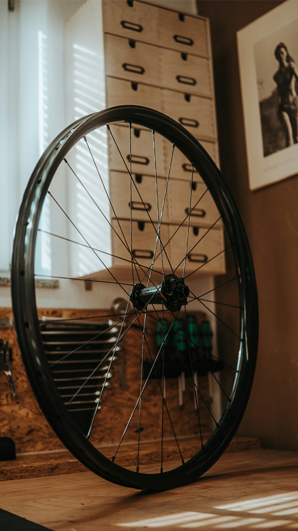 a bicycle wheel sitting on top of a wooden table