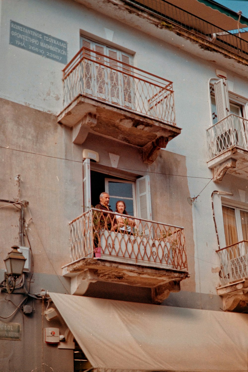 a couple of people that are standing on a balcony