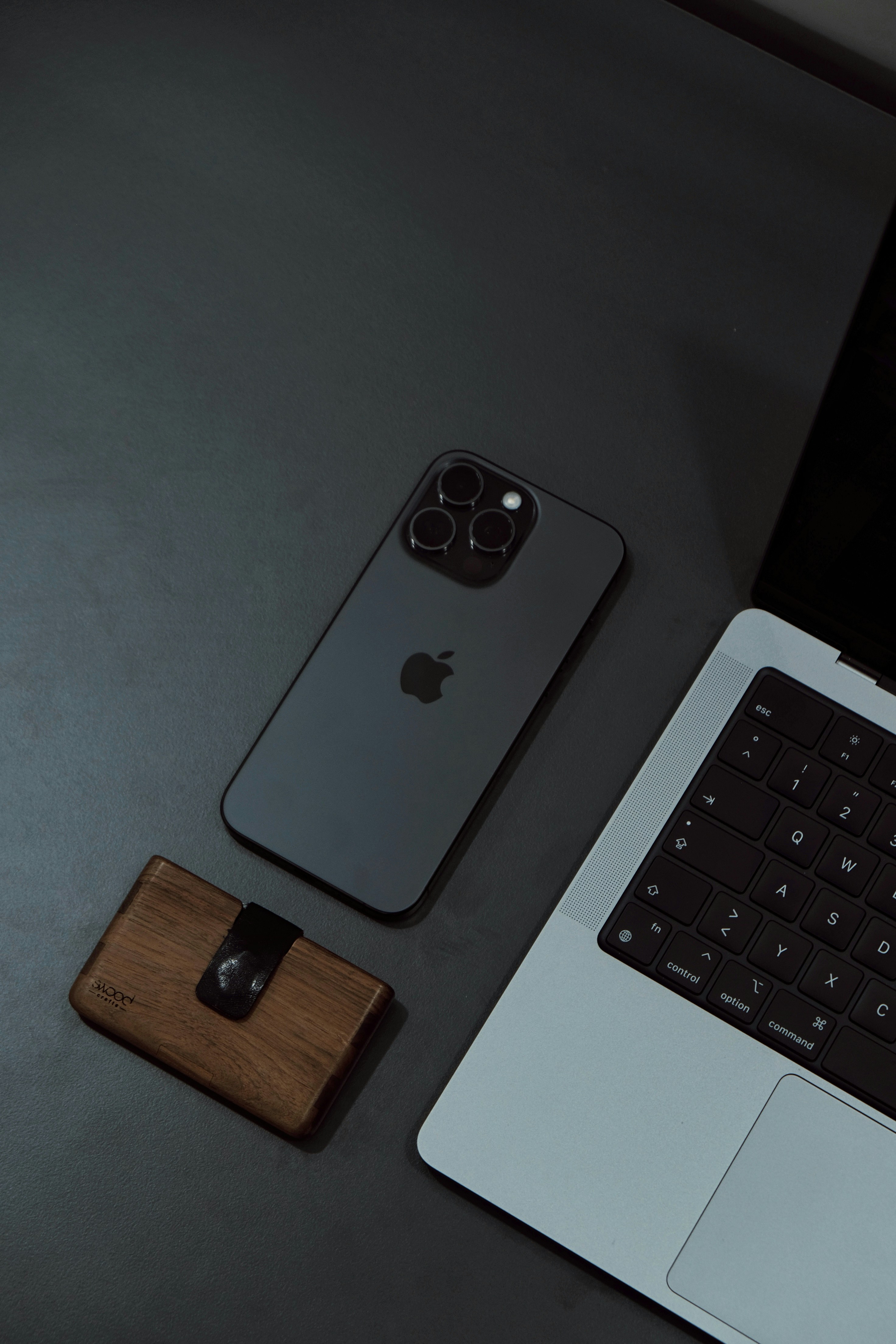 una computadora portátil colocada encima de un escritorio junto a un teléfono