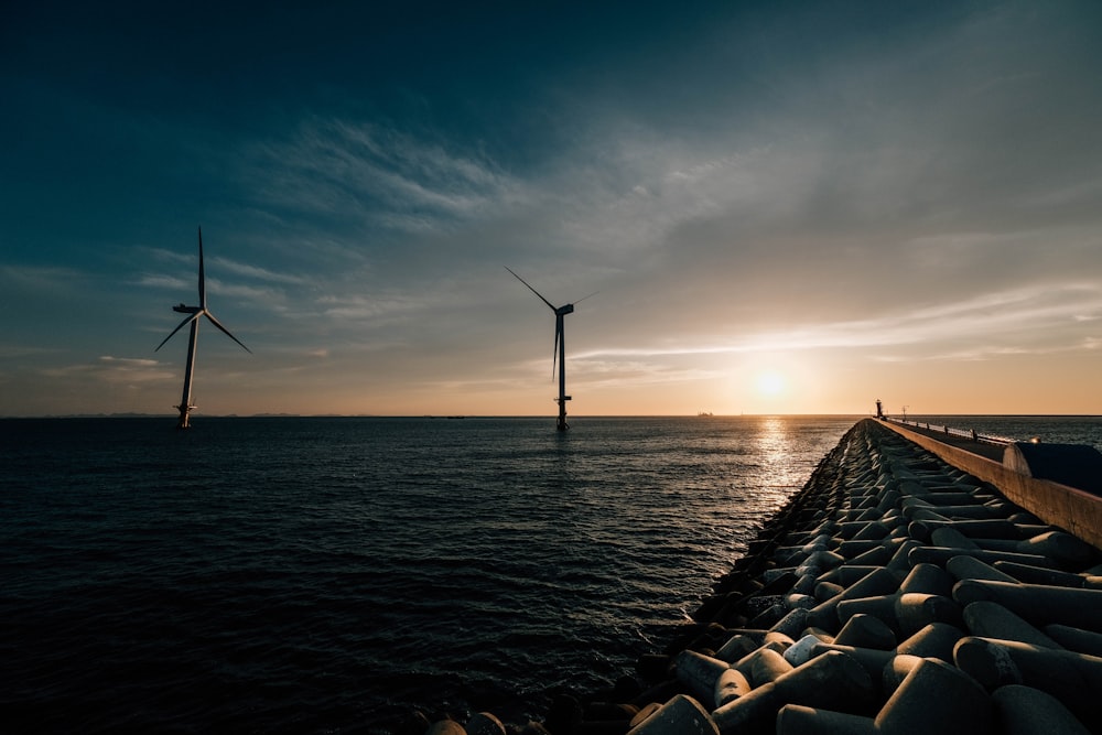 a couple of windmills that are in the water