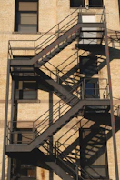 a tall building with a fire escape next to it
