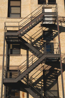 a tall building with a fire escape next to it
