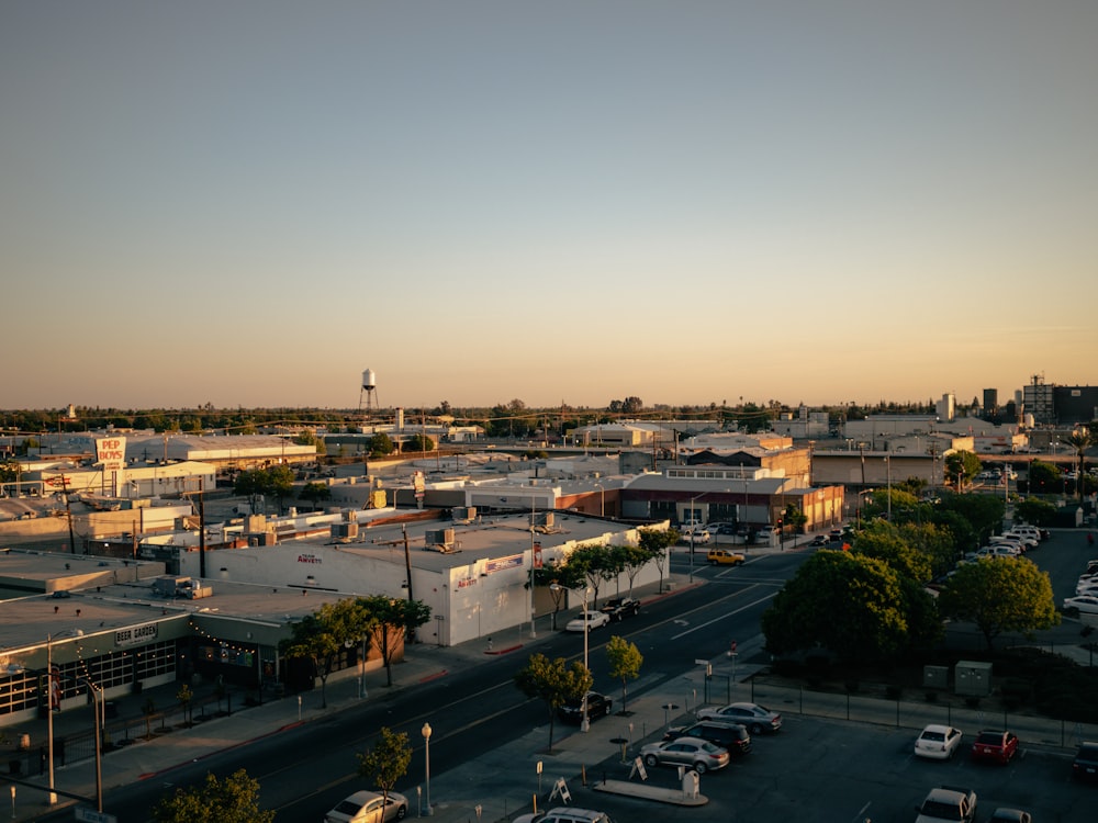 a view of a city street with cars parked on the side of the road