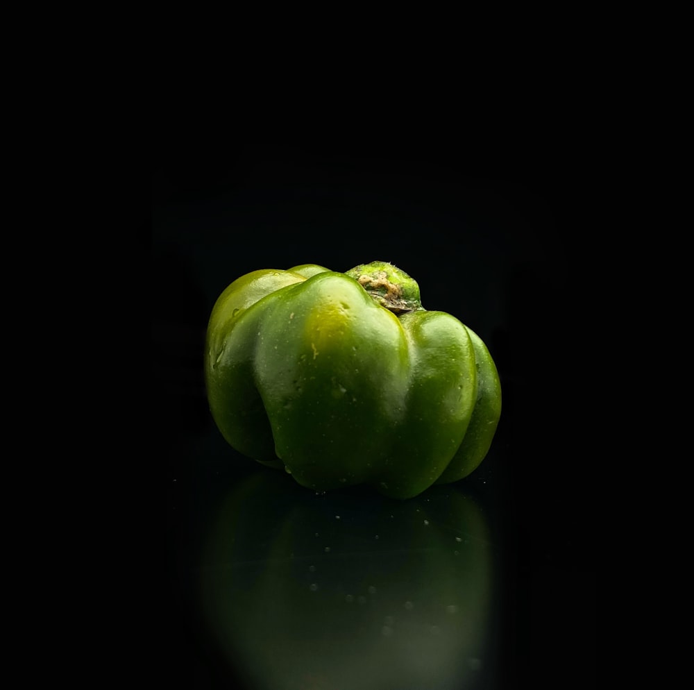a group of green peppers sitting on top of a table