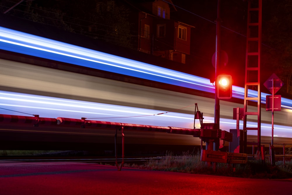 a blurry photo of a train passing by at night