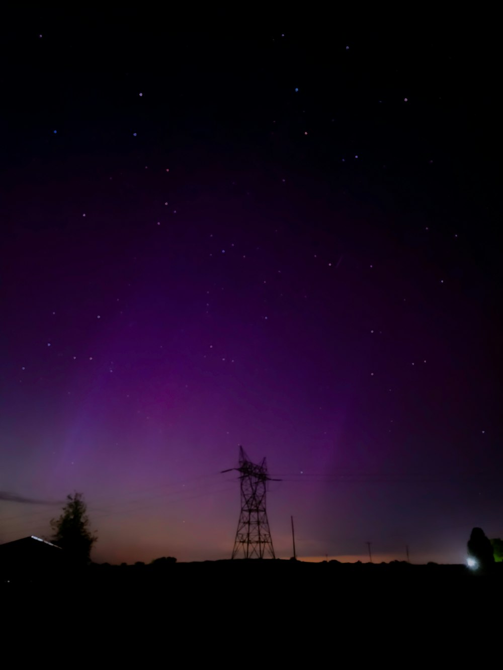 a purple and purple sky with a tower in the foreground