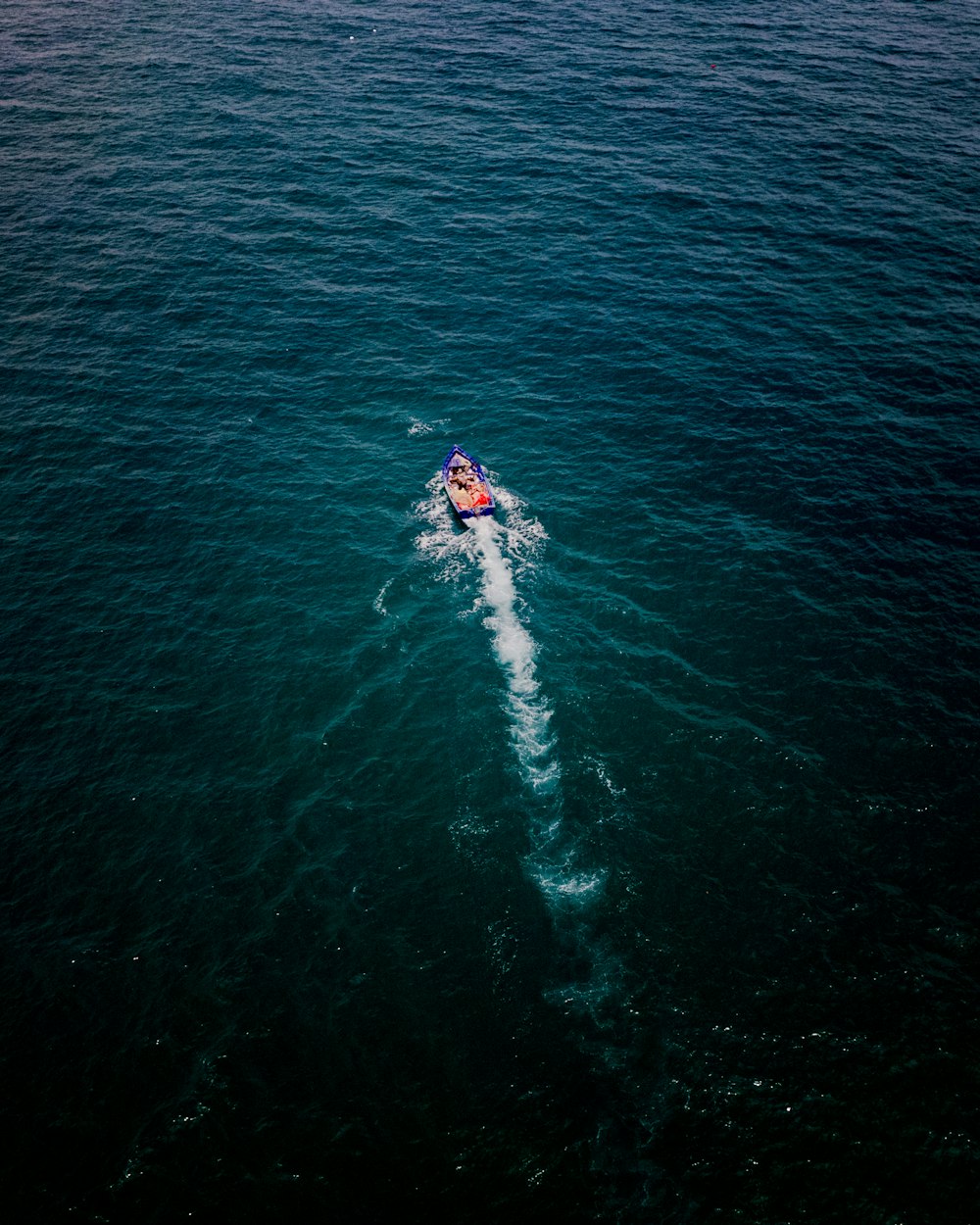 a person on a boat in the middle of the ocean
