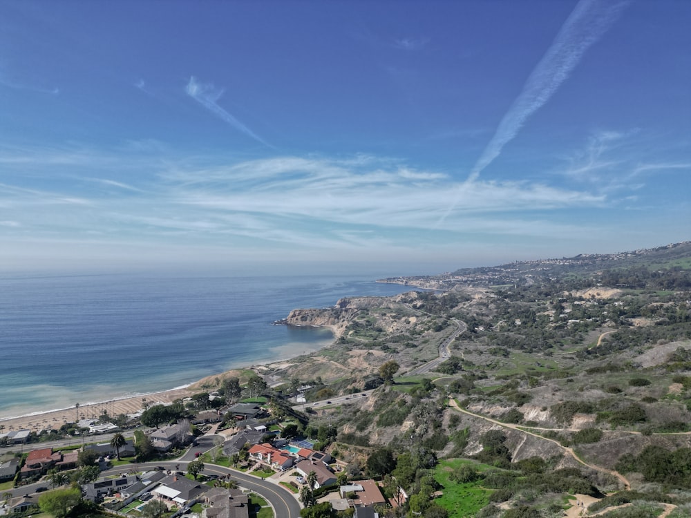 a scenic view of a beach and ocean from a hill