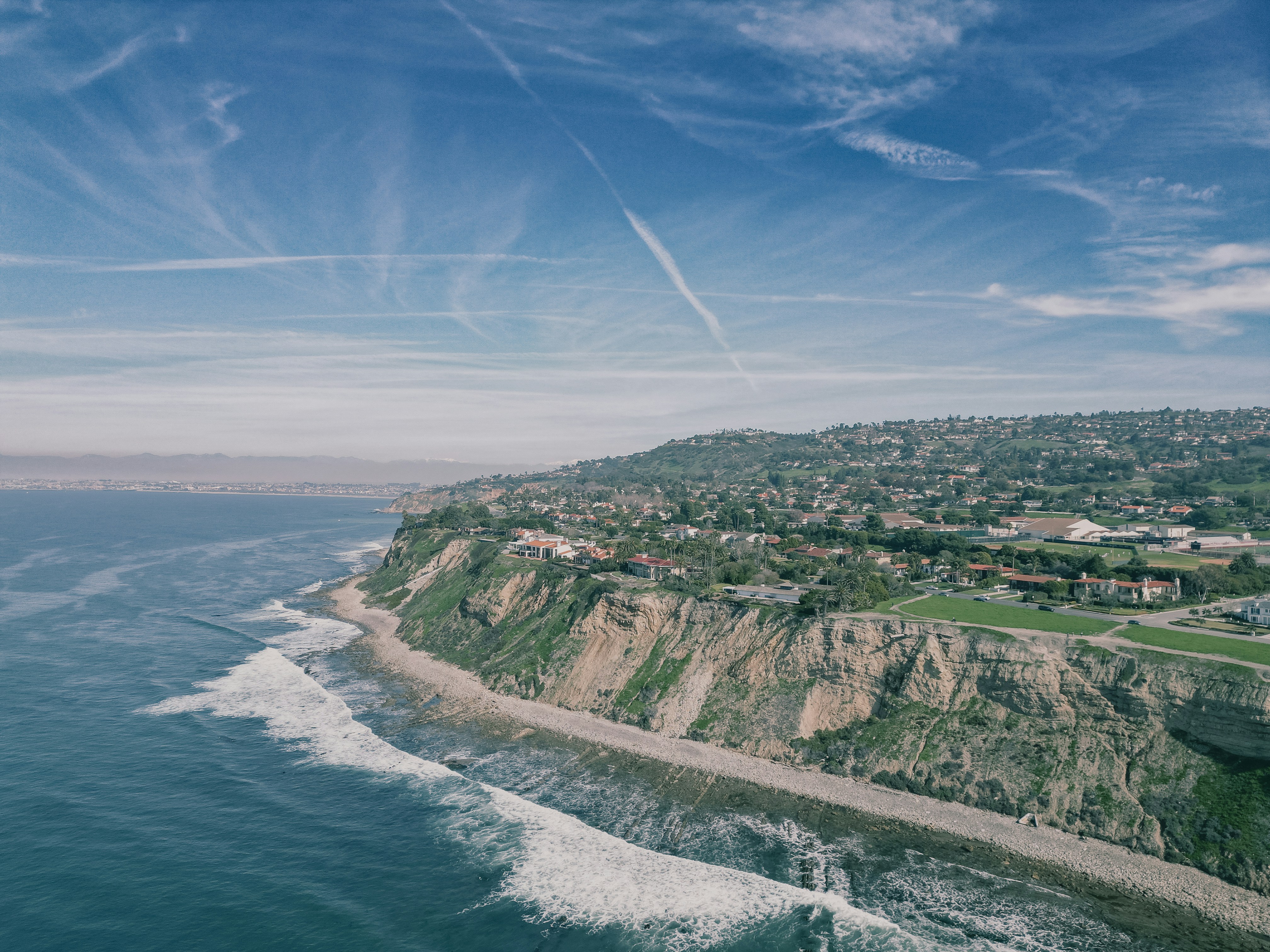 an aerial view of the ocean and a city