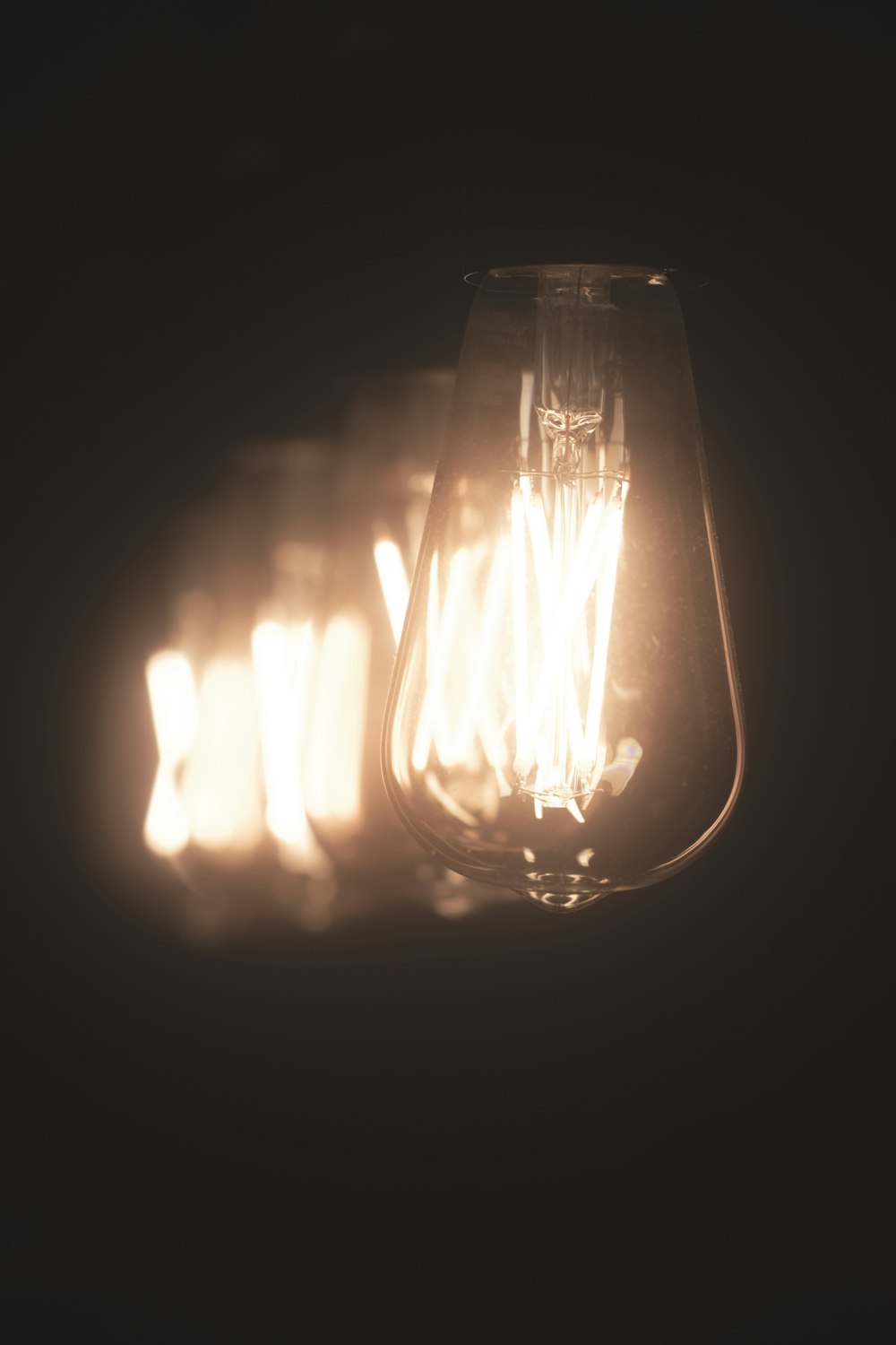 a close up of a light bulb in a dark room