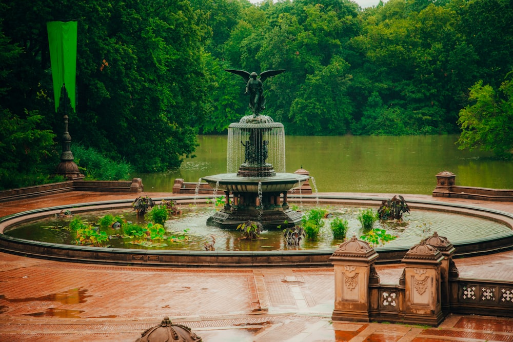 a fountain with a bird statue on top of it