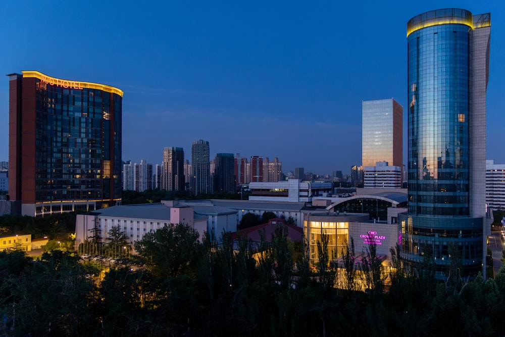 a view of a city at night with tall buildings