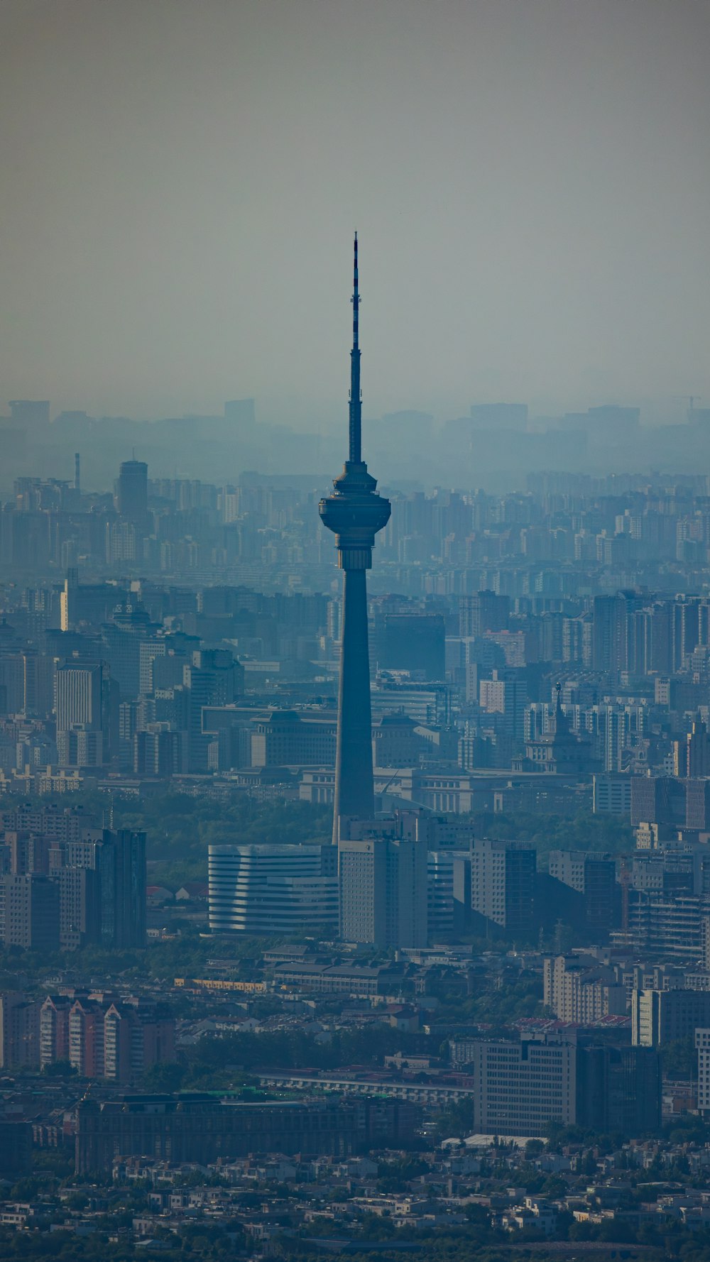 a view of a very tall tower in the middle of a city