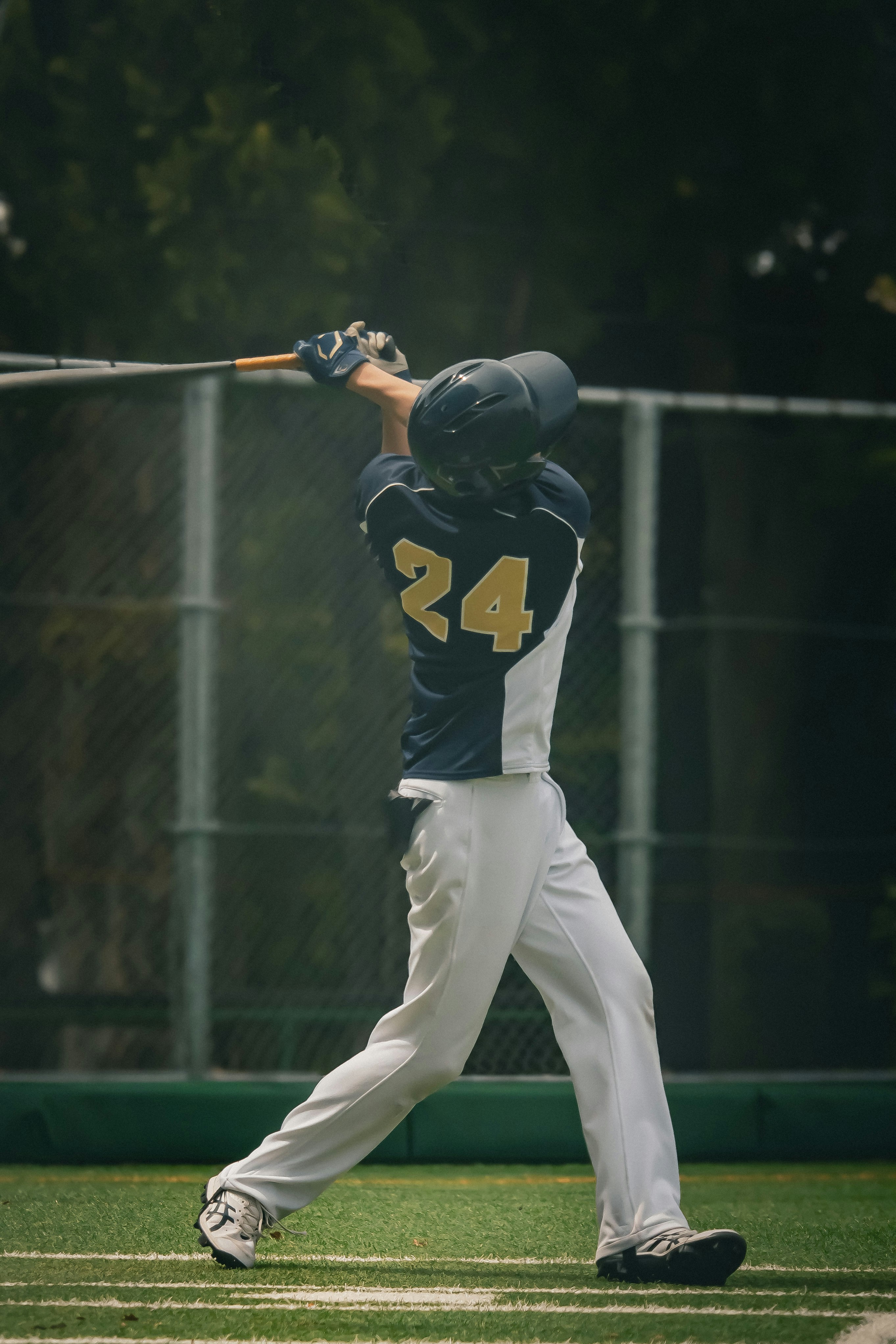 a baseball player swinging a bat at a ball