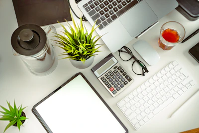 a laptop computer sitting on top of a white desk