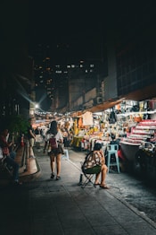 a woman sitting in a chair in a market