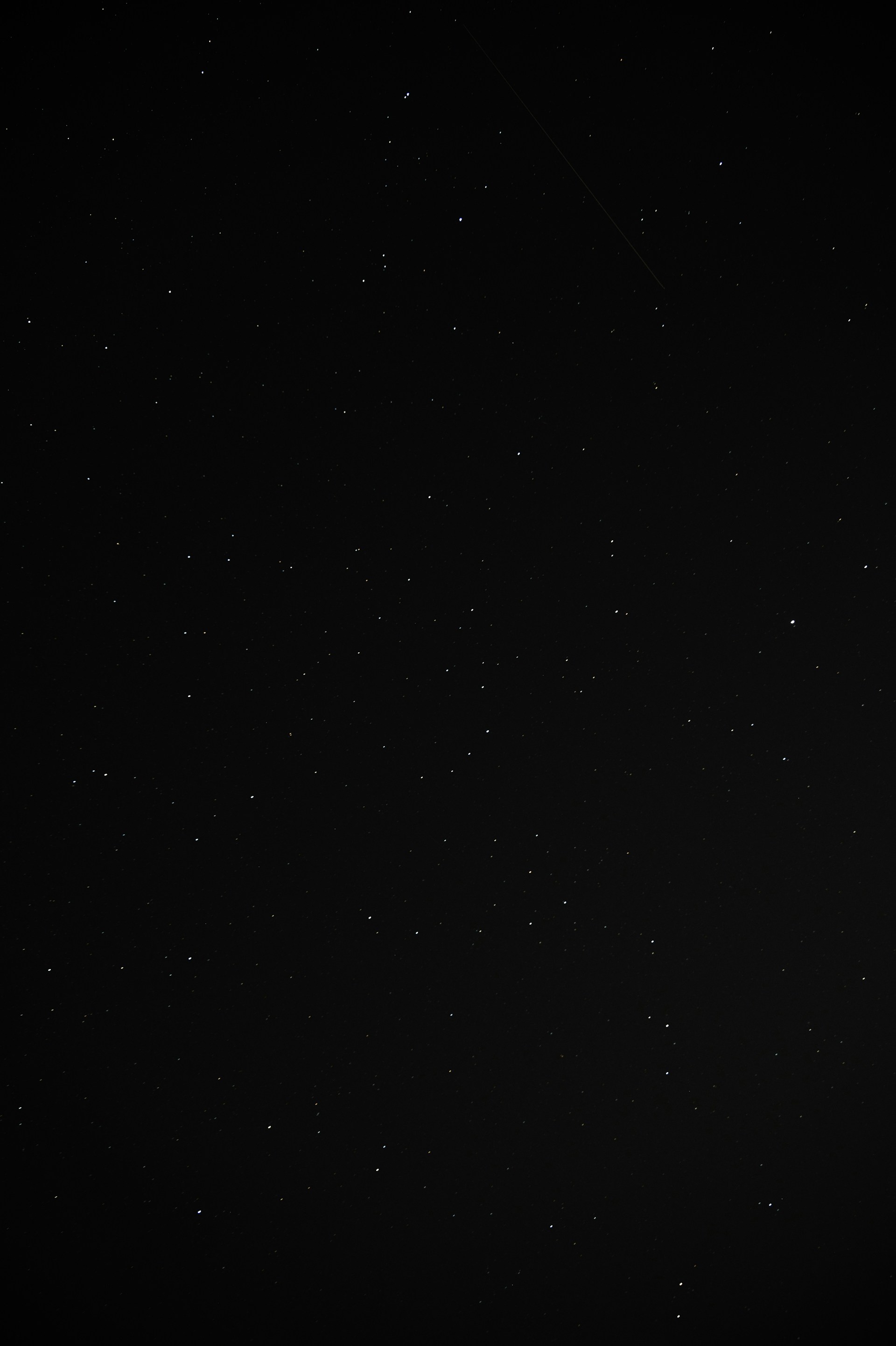 a black and white photo of a plane in the sky