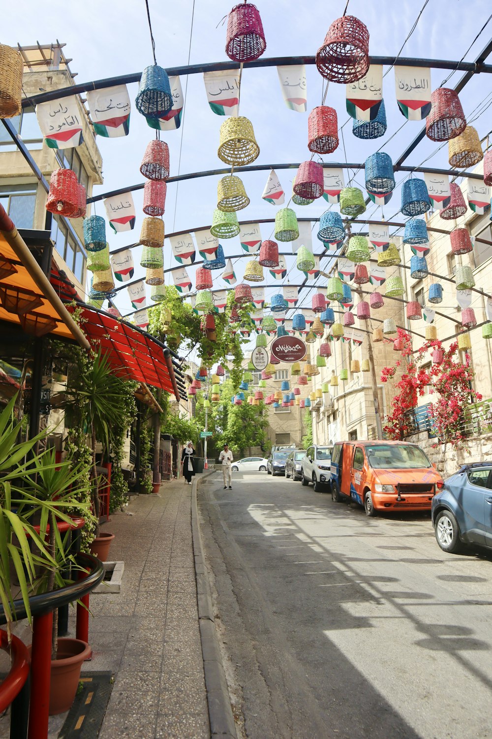 a city street lined with lots of colorful paper lanterns